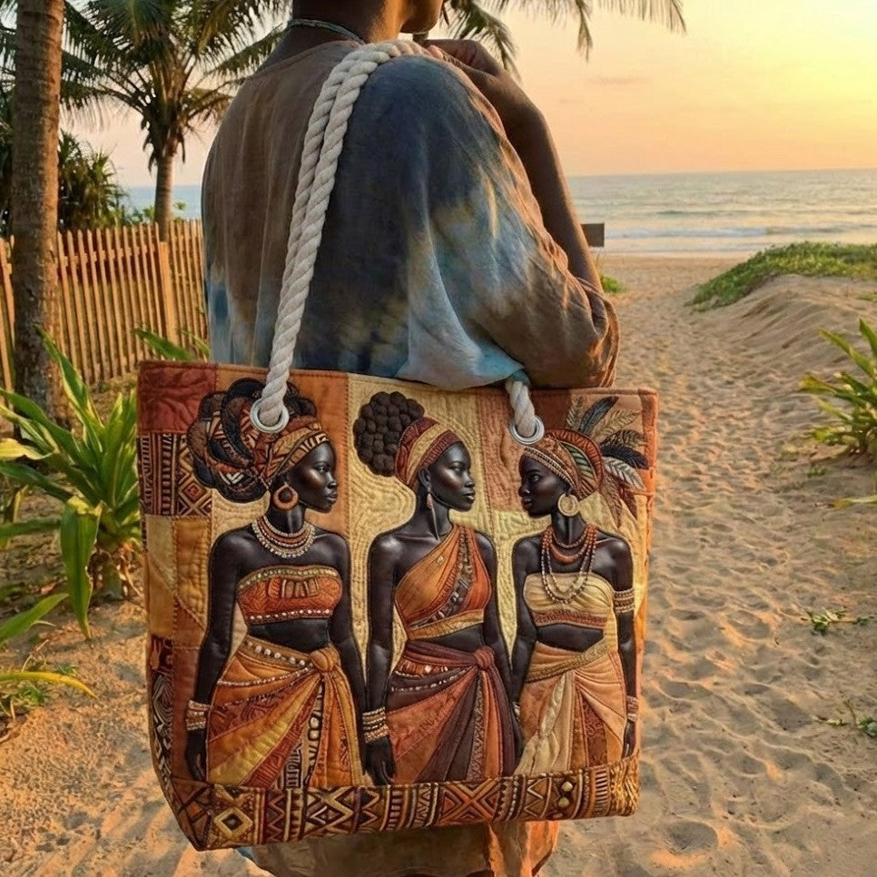 Handheld beach tote with quilted patchwork of three figures and braided rope handles.