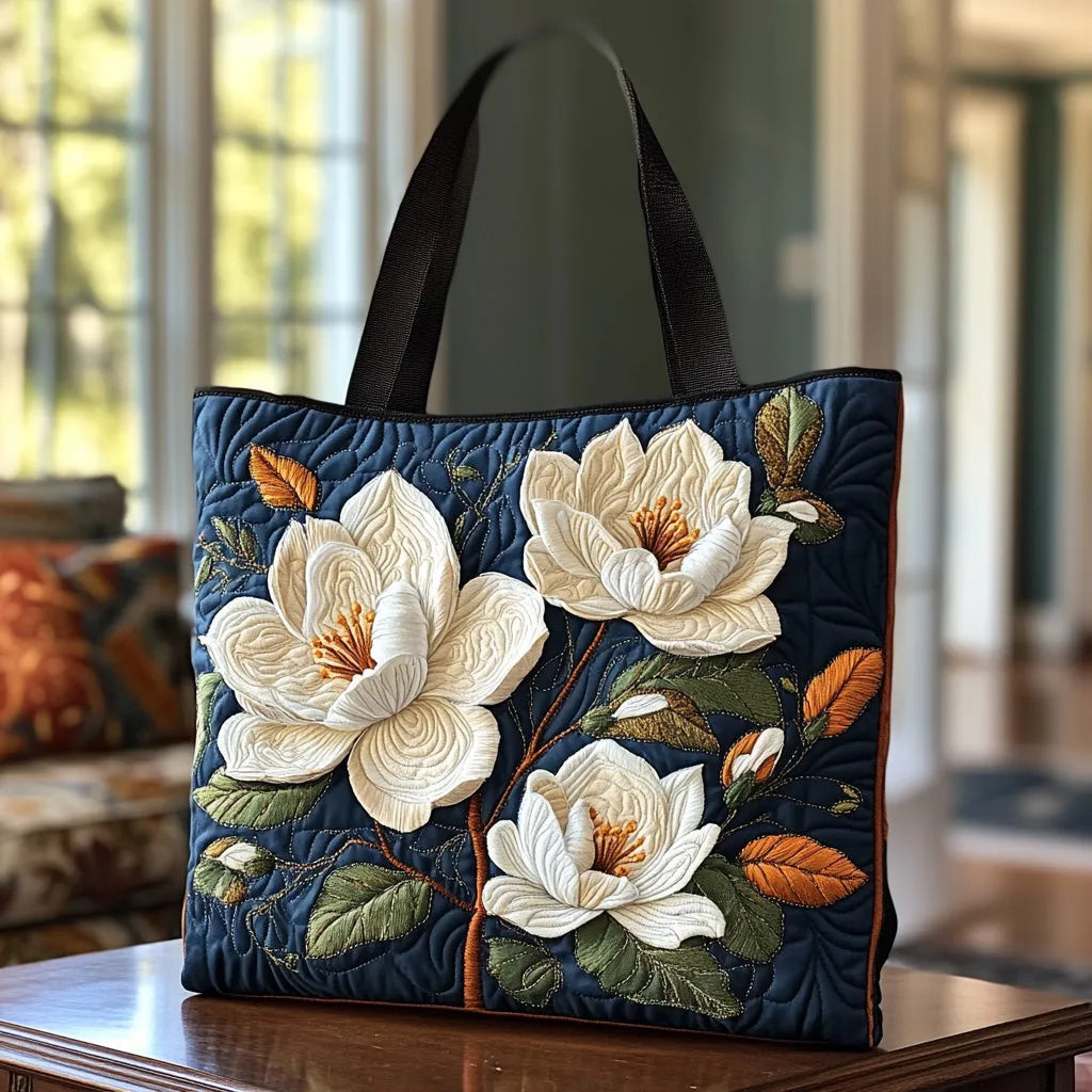 Handcrafted tote bag with quilted navy fabric and magnolia floral embroidery