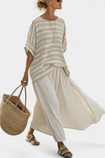 Cream striped loose blouse with draped hem and pleated skirt set, side view
