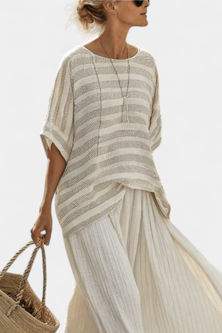 Cream striped blouse with draped hem over pleated skirt, elegant set