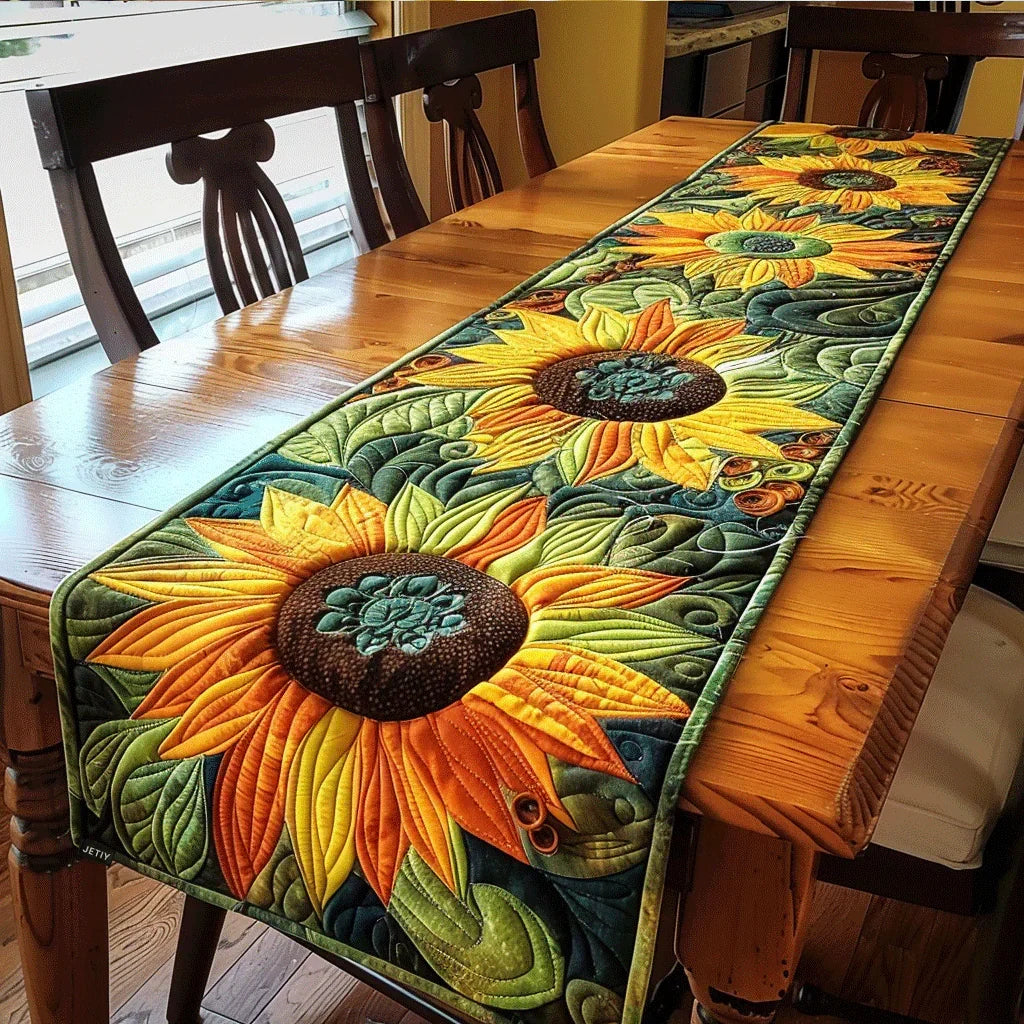 Quilted table runner with colorful sunflower and leaf patchwork, dark green border.