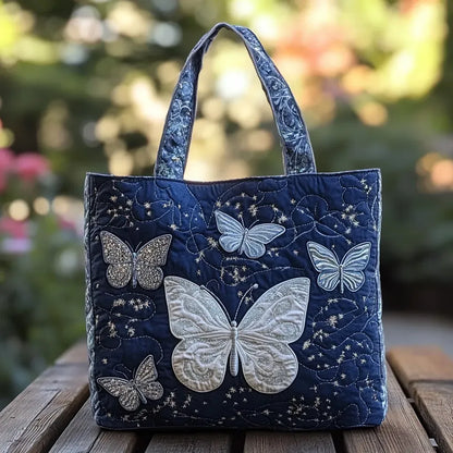 Handcrafted tote bag with dark navy quilted fabric and silver embroidered butterfly motif
