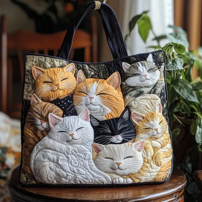Quilted tote bag with embroidered cat faces in orange, gray, black, and white