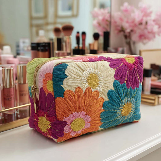 Padded makeup bag with multicolor daisy floral embroidery and zip closure