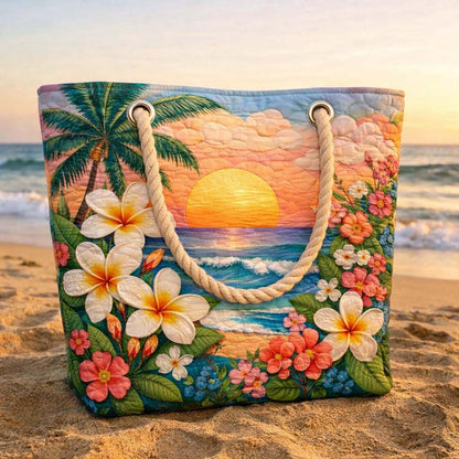 Tote beach bag with quilted tropical sunset scene, plumeria flowers, and rope handles