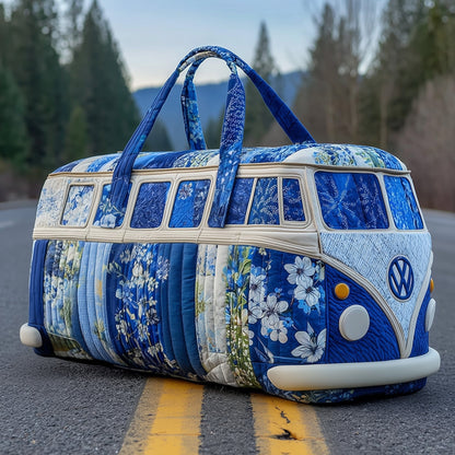 Blue quilted duffle bag with floral pattern, round front emblem, long handles