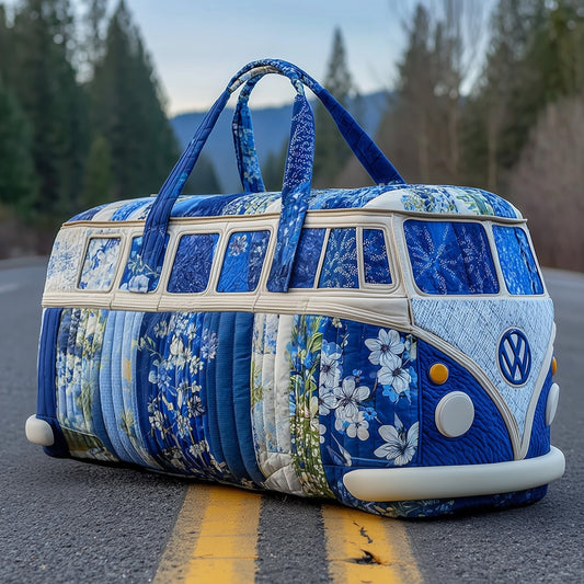 Blue quilted duffle bag with floral pattern, round front emblem, long handles