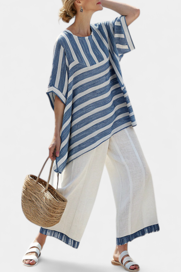 Striped blue tunic over cream wide-leg pants with blue hem trim