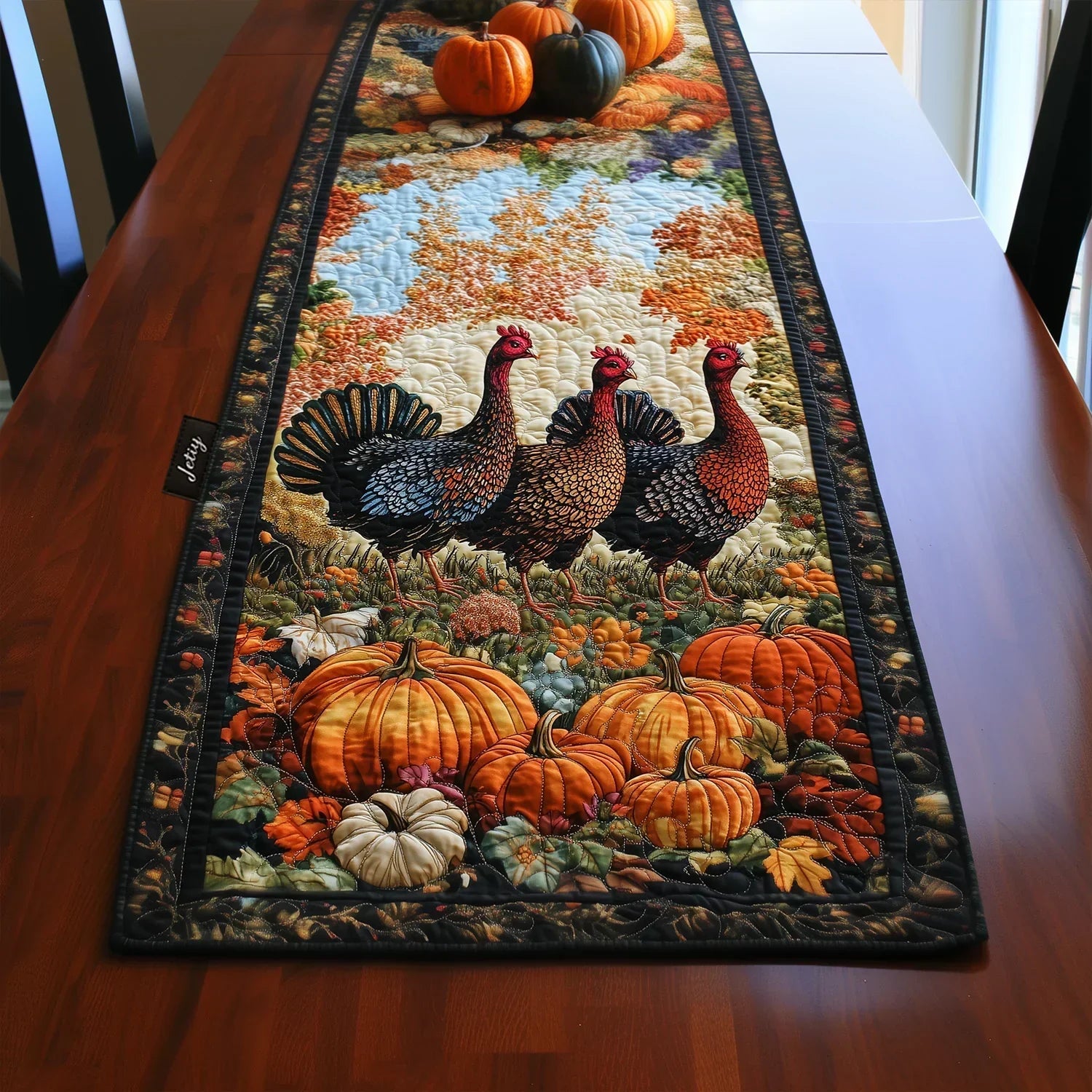 Quilted table runner with turkeys and pumpkins in autumn colors