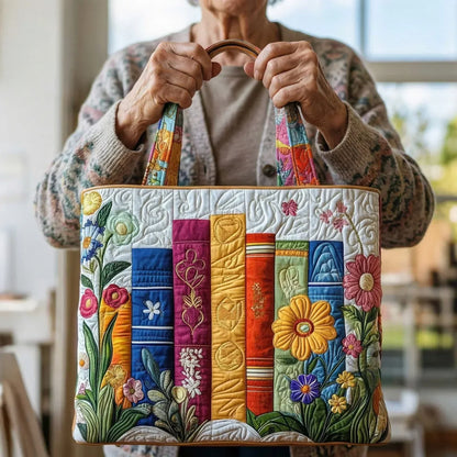 Quilted floral patchwork tote bag with brown handles, striped multicolor front panel.