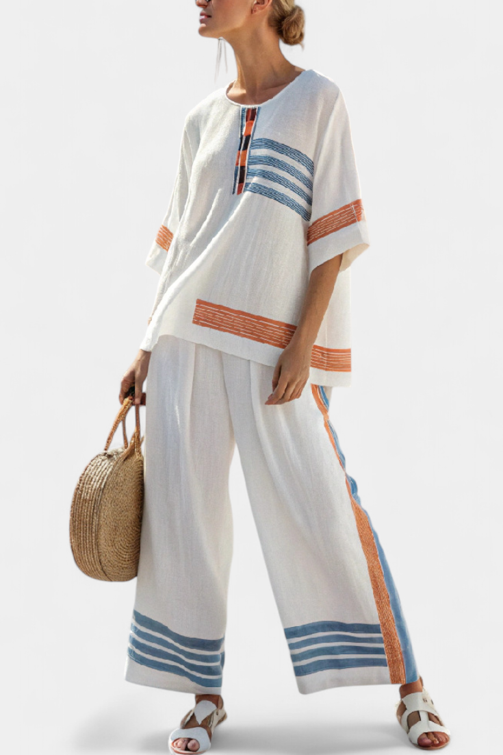 White tunic and wide-leg pants set with blue and rust stripe trim